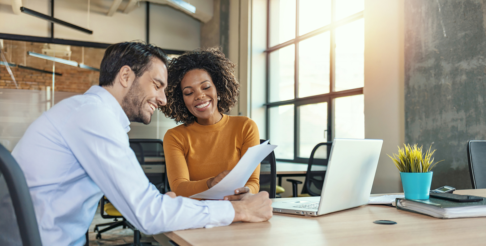 Photo of two people working together